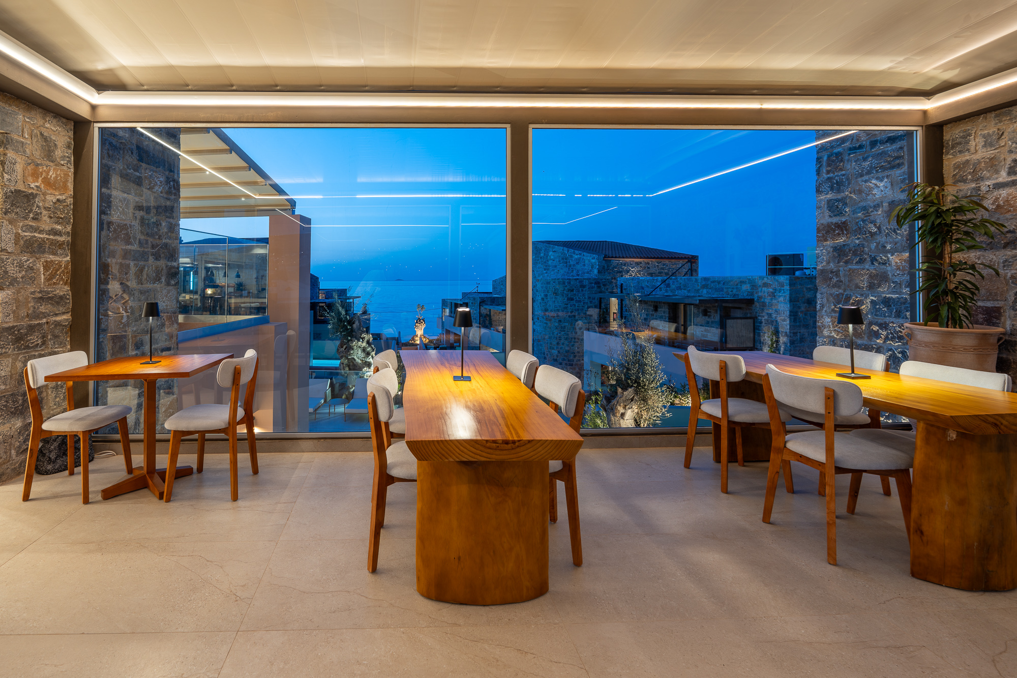 Indoor dining with sea view at dusk