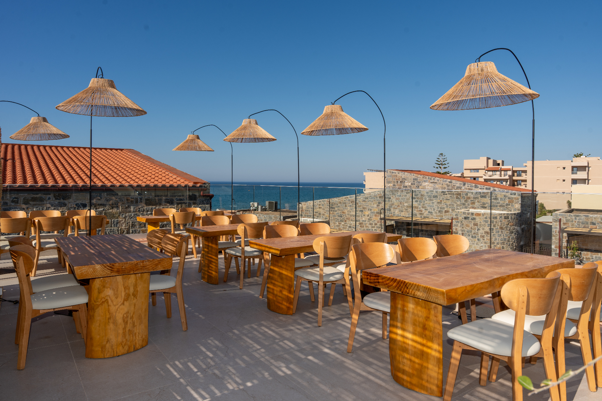 Rooftop terrace with rattan lamps and sea view