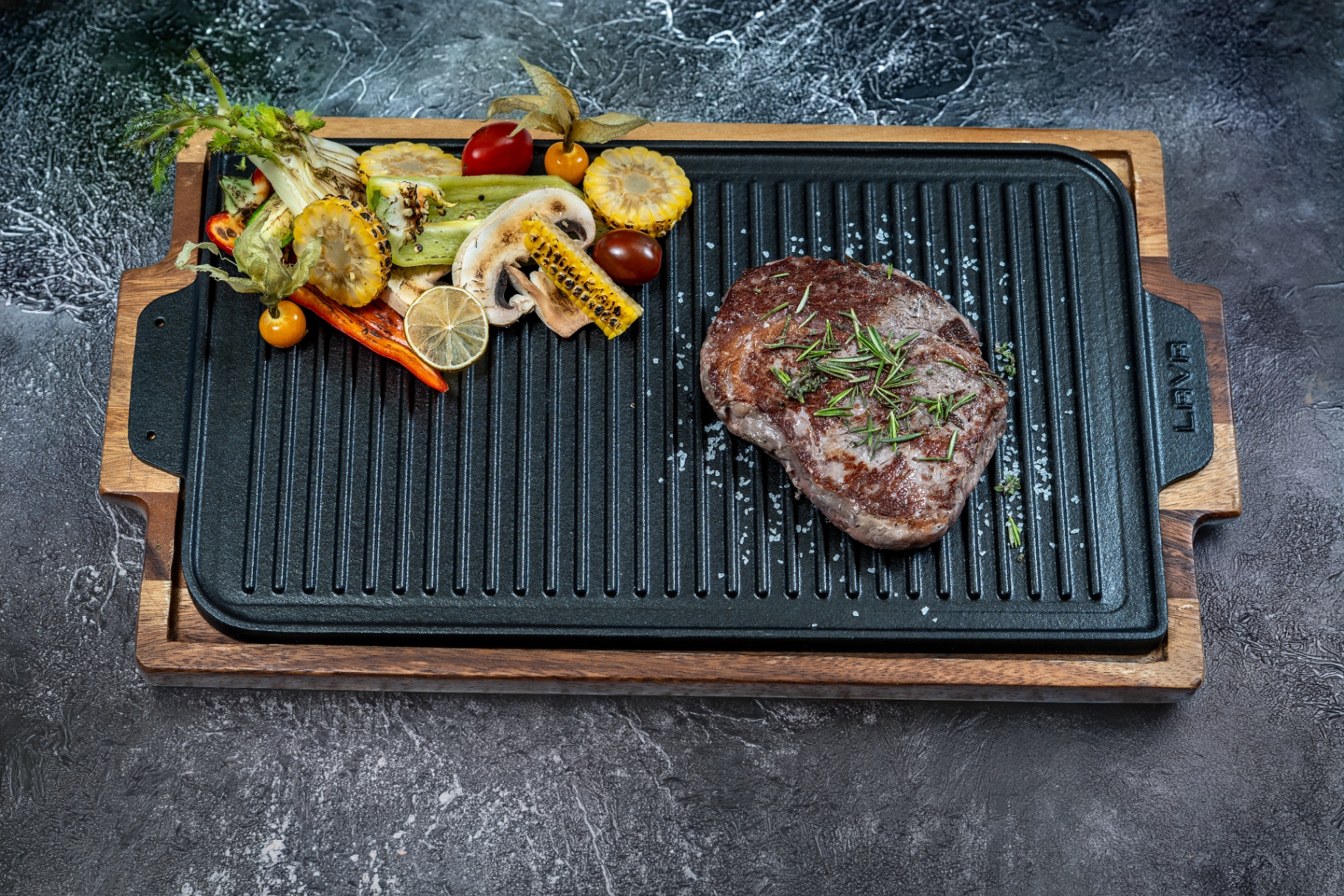 Grilled steak with vegetables on cast iron